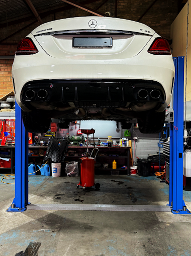 Car on hoist in workshop